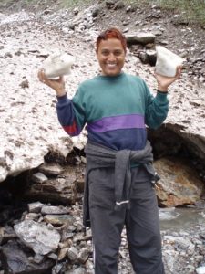 Suresh with snow and ice from the small glaciel river in the Valley of Flowers, India 2006