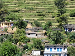 Rice terraces, slate rooved houses, hay stacks and village people, Himalayan India