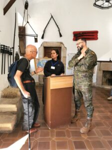 Manfred speaking with two people in the entrance to a museum in Cáceres