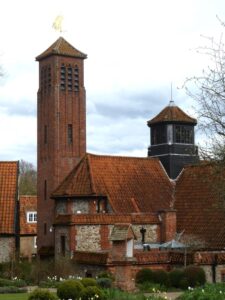 The steeple with the weather vane and the church at the Shrine of Mary