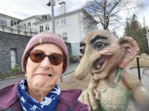 Having fun with the troll sculpture on Mt Fløyen