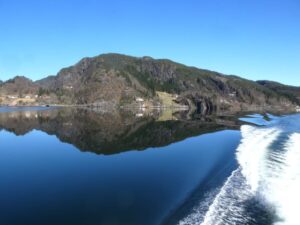 Reflections on the fjord, wake from the boat