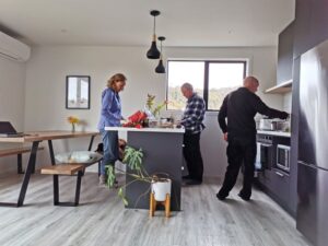 Leonetta, Andy and Manfred cooking in the kitchen at Argyle Apartments, Stewart Island Rakiura