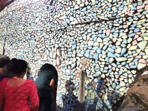 Going through a small doorway in the ceramic mosaic wall at the Rock Garden Chandigarh