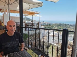Manfred on the balcony at El Agarve with the view to the Mediterranean Coast
