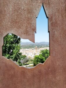 One of the church's in Vélez-Málaga as seen through a sculpture in the grounds of 'Our Lady of the Remedies' Ermita de la Virgen de los Remedios
