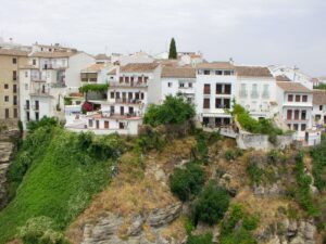 Beautiful houses on the cliff opposite Mirador de Aldehuela near Puente Nuevo Bridge Ronda