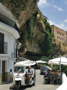 The cave restaurants and a golf cart transporting visitors at Setenil de las Bodegas