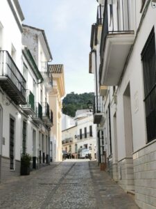 A narrow cobbled street with Juliet balconies in Ubrique