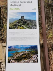 A signboard showing the 'castle on the hill' check out the cliff below the castle - Zahara de la Sierra