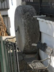 An old Olive mill stone being used as a water fountain in Plaza de la Alameda, Villaluenga del Rosario
