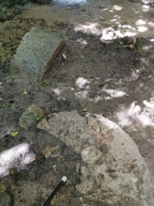 Half buried flour mill stones at El Molino del Susto