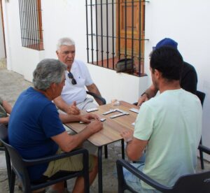 Local men playing dominos in a side alley in Grazalema