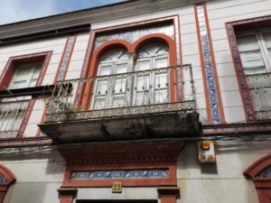The Julet balcony of a building facade under renovation, with mosaic tiles in Ubrique