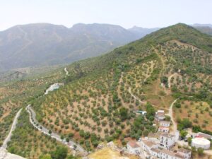 The road and carpark at the back side of Zahara de la Sierra and the hills towards the Grazalema National Park mountains