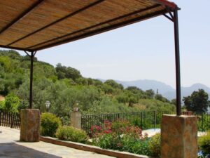 The shaded resting area above the swimming pool with a view to the Grazalema National Park mountains from El Tajo