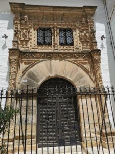 An ornate doorway in Santa Cruz behind a wrought iron fence