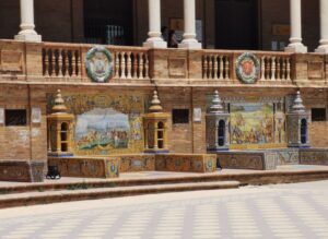 Two of the provincial tiled alcoves with the coat of arms below the veranda of Plaza de España