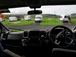 From the front of the campervan over the camping ground towards the Cliffs of Moher