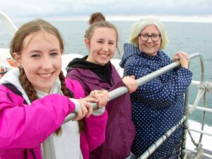 Matilda, Francesca and Dionee on the boat by the Cliffs of Moher