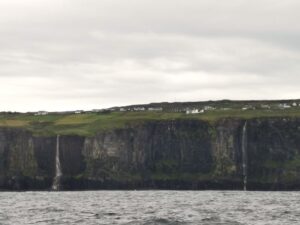 Twin waterfalls fall from the cliffs near Doolin