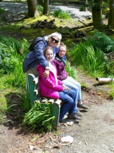 Dionee, Matilda and Francesca sitting by the lake at Kylemore Abbey