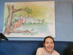 Matilda in the kitchen under a painting of a bird at Kylemore Abbey