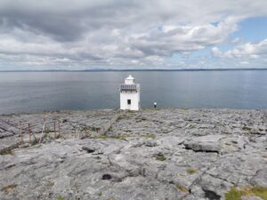 The Blackhead Lighthouse above Galway Bay sitting on the striated rocks in The Burren