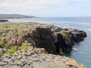 The view from cliffs at The Burren back to Doolin and the Cliffs of Moher