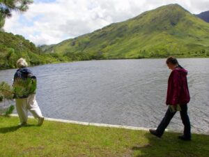 Walking along the edge of Pollacapall Lough to the church at Kylemore Abby