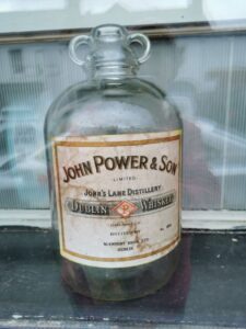 An old whiskey 'bottle' in the window of a store in Belmullet