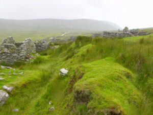 Deserted village houses Achill Island and the road beyond