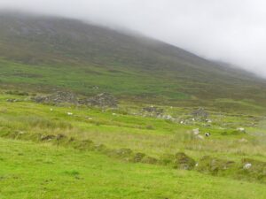 Houses of the deserted village below a misty Slievemore, Achill Island