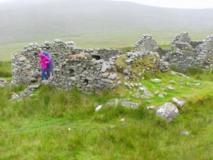 Matilda and Dionee coming out of one of the deserted village houses on Achill Island