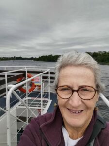 Teresa on the boat on Lough Derg with the Shannon River Killaloe behind