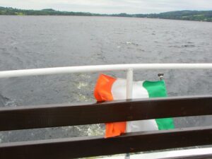 The Irish Flag flutters on the back of the boat on Lough Derg