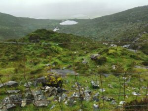 Corrie lakes or Tarns as seen from the road at Conor Pass Waterfall disappearing into the mist