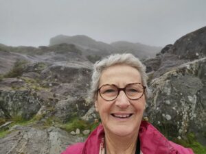 Teresa at the Conor Pass Waterfall carpark and the misty rocks above the road