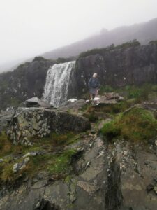 The Conor Pass waterfall and the slippery rocks. Dionee up on the rocks
