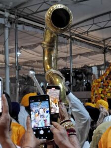A horn being blown during the transport of the The Book of Wisdom, Guru Granth Sahib to the Golden Temple