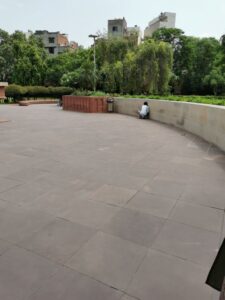 The other end of the curved wall with the friend listening to the message moving along the wall