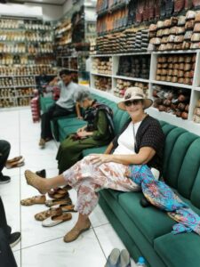 Trying Punjabi Juttis, Mojaris, shoes on in one of the multiple shoe stores