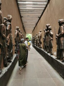 Walking between the bronze statues in the narrow alleyway into Jallianwala Bagh