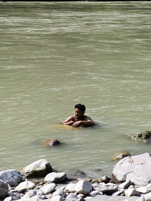 Kartik taking a ceremonial dip in the holy Ganges