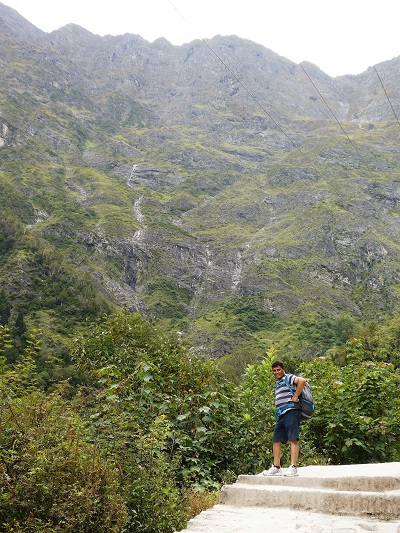 Suresh waiting for me on the trek to Gangaria base camp with the high Himalayas as his backdrop. Valley of Flowers, Himalayas, India