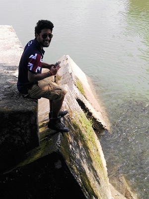 Kartik feeding the carp at Baijnath