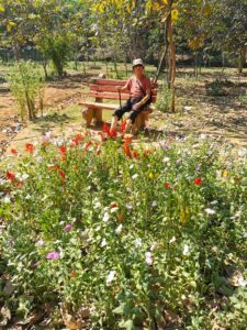 Manfred among the flowers in the Auyervedic garden near KIBI