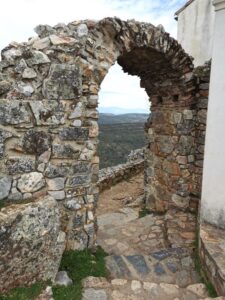 A view through a rock archway from the Castillo de Monfragüe