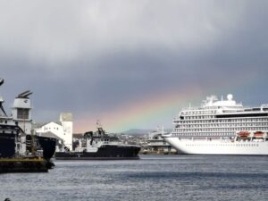 A rainbow over the fjord beyond the harbour and the sanctuary of the harbour