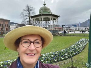 In front of the spring flowers and band rotunda near the centre of Bergen